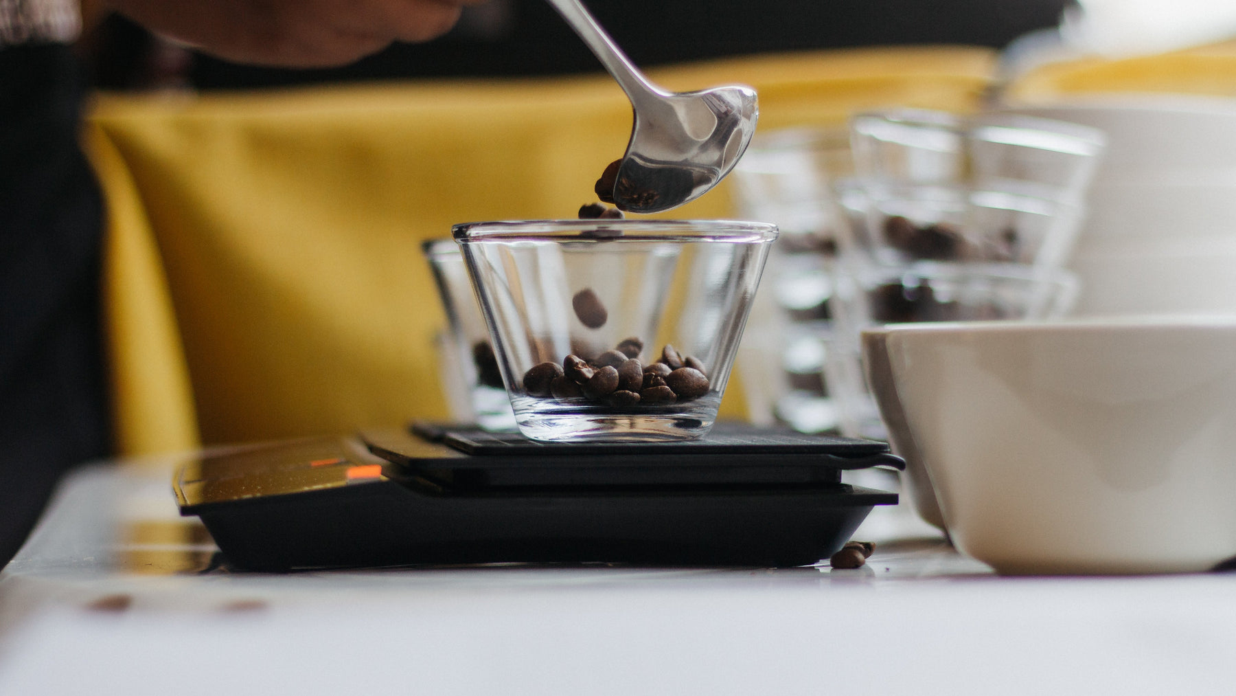 dosing coffee in a small glass