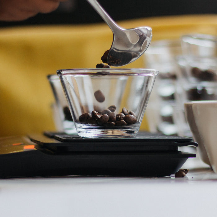 dosing coffee in a small glass