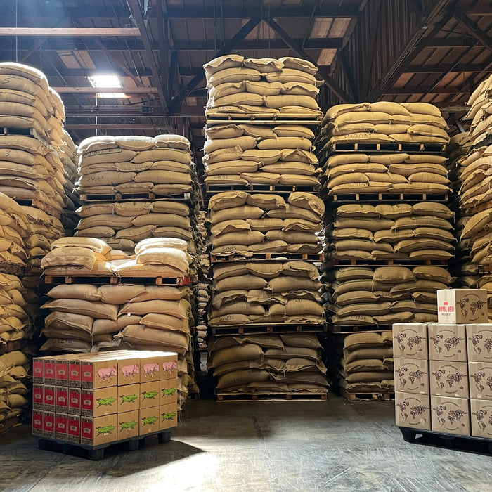 Coffee warehouse with stack of coffee bags