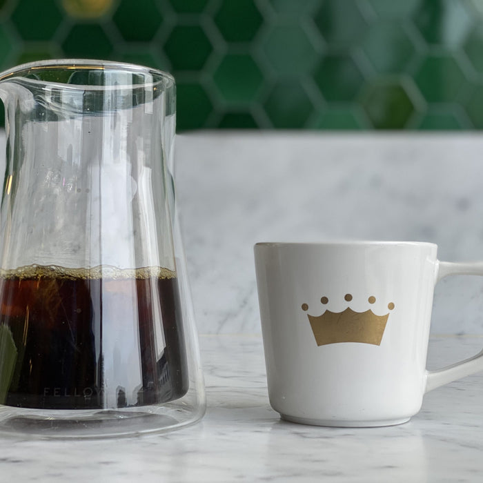 coffee mug with glass pitcher of coffee