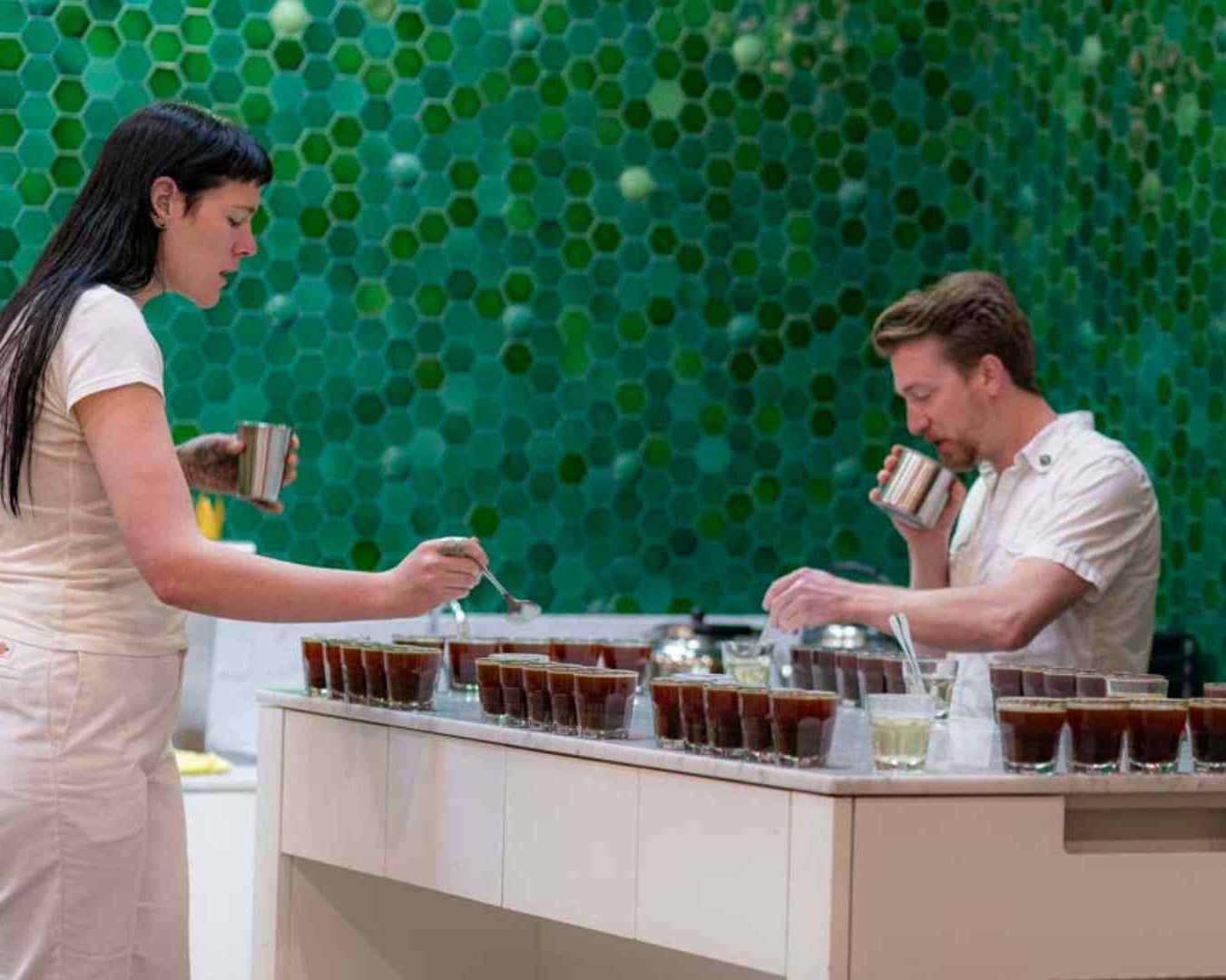 Asha, Chris, and Doris are cupping coffee