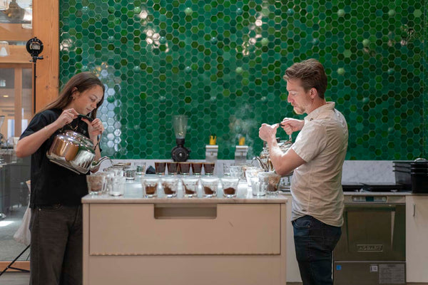 Isabella and Chris cupping coffee